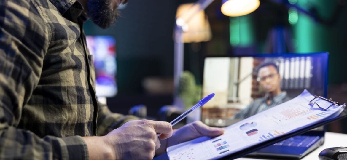 Man reviews documents while on video call