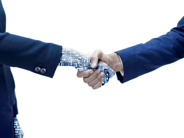 man-shaking-hand-with-robotic-arm